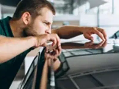 Fachmann prüft den Zustand eines Fahrzeugs zur Bewertung des Restwerts im Leasing